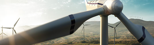 Happy engineer feel success after good work. He standing a top of windmill and looking beautiful sunset landscape