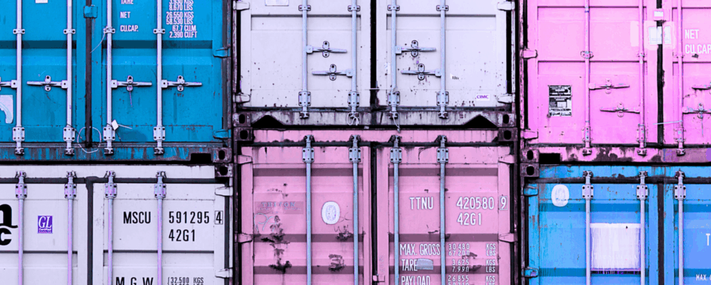 shipping containers of different colors stacked on top of each other